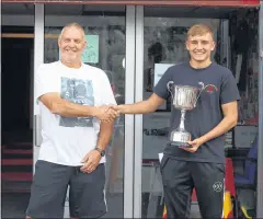  ??  ?? Young Peoples Cup winner Aaron Duncan receives his trophy from head coach Paul Cooke