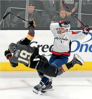 ??  ?? Reilly Smith, left, of the Knights collides with Capitals defenceman John Carlson during Game 2.
AP