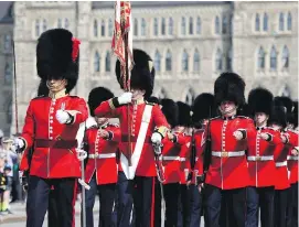  ?? THE CANADIAN PRESS ?? A man has been arrested after trying to attack a soldier on Parliament Hill on Monday. Members of the ceremonial guard are seen in a Changing of the Guard ceremony in Ottawa.