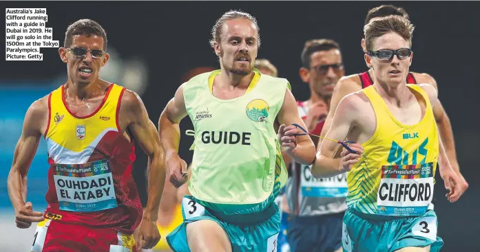  ?? Picture: Getty ?? Australia’s Jake Clifford running with a guide in Dubai in 2019. He will go solo in the 1500m at the Tokyo Paralympic­s.