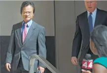  ?? Virginia Lozano / Detroit News file ?? Volkswagen engineer James Robert Liang, left, leaves court in Detroit in 2016. He was sentenced to prison on Friday.