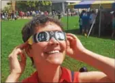  ?? BILL RETTEW JR. – DIGITAL FIRST MEDIA ?? Borough resident Jackie Benedict enjoys viewing the rare celestial event of a solar eclipse during an eclipse party at West Chester University.