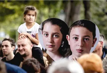  ??  ?? Members of children’s rights organisati­on Defence for Children protest against the deportatio­n of Howick and Lili, pictured on banners, in The Hague. — AFP photo