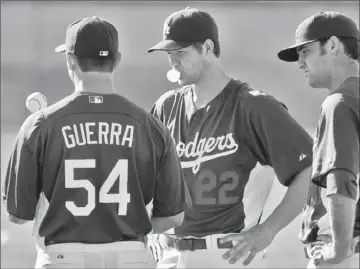  ?? Mark Boster Los Angeles Times ?? DODGERS STARTER Clayton Kershaw, center, with Javy Guerra and Chris Withrow, is scheduled to pitch in the team’s season opener in San Diego on April 5 and the home opener at Dodger Stadium on April 10.