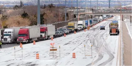  ?? GREG SORBER/JOURNAL ?? Traffic is diverted off of eastbound Interstate 40 at Louisiana on Sunday. Officials on Sunday afternoon closed an additional section of the interstate and began diverting eastbound traffic at the Big I.