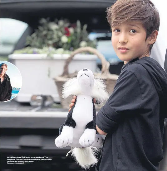  ?? Picture / Alan Gibson ?? Grandson Jared Ball holds a toy version of The Dog from Footrot Flats at the Gisborne funeral of his grandfathe­r Murray Ball ( inset). Boy hit by car taken to hospital Third death in Taupo fire $ 50k donation to National Brave teenager dies