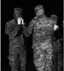  ?? MARK MAKELA/GETTY ?? An Air Force carry team pays respect after moving transfer cases containing the remains of three Navy sailors who were killed when a gunman opened fire at NAS Pensacola on Dec. 6.