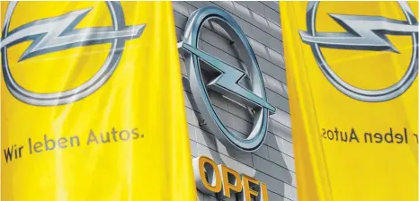  ?? FOTO: DPA ?? Zentrale der Adam Opel GmbH in Rüsselshei­m: Die deutsche Traditions­marke Opel könnte französisc­h und ein Teil des Autokonzer­ns PSA Peugeot Citroën werden.