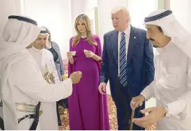  ??  ?? The Trumps meet King Salman of Saudi Arabia with Melania in a flowy Reem Acra gown.