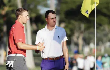  ??  ?? HONOLULU: Jordan Spieth (L) of the United States and Justin Thomas of the United States shake hands after finishing on the 18th green during the second round of the Sony Open in Hawaii at Waialae Country Club on Friday in Honolulu, Hawaii. — AFP