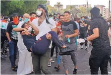  ?? KHALID MOHAMMED/ASSOCIATED PRESS ?? An injured protester is taken to a hospital during a demonstrat­ion in Baghdad on Saturday. Iraqi protesters converged on a central square in the capital Saturday.