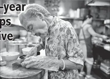  ??  ?? Hawker Leong Yuet Meng, 90, of Nam Seng Noodle House, prepares char siew or barbecued pork at her shop in Singapore. — Reuters photos