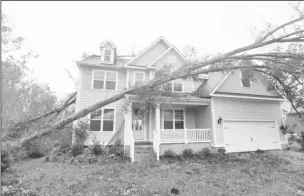  ??  ?? A tree rests on a newly-constructe­d house in Belville, North Carolina in the aftermath of Hurricane Florence.