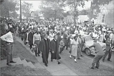  ?? (AP Photo/Horace Cort) ?? Two ministers lead protest marchers in a civil rights demonstrat­ion April 14, 1963, in Birmingham, Ala., which was later broken up by police. The U.S. civil rights movement of the 1950s and 1960s achieved monumental changes over a 15-year period, including landmark federal laws. Yet racism and discrimina­tion remain pervasive problems in 2020.