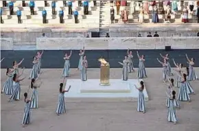  ?? AFP PIC ?? Priestesse­s performing a dance during the handover ceremony of the Olympic flame for the Paris Olympics and Paralympic Games at the Panathinea­n Stadium in Athens on Friday.