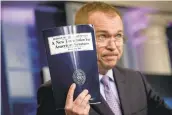  ?? ANDREW HAMIK/ASSOCIATED PRESS ?? Budget Director Mick Mulvaney holds up a copy of President Donald Trump’s proposed fiscal 2018 federal budget as he speaks to members of the media Tuesday.