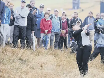  ??  ?? 0 Fans gather around Ariya Jutanugarn on the 18th hole at Gullane on Sunday as she homes in on the Ladies Scottish Open, but crowd figures were disappoint­ing for an event which deserved a higher attendance