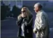  ?? GREGORY BULL — THE ASSOCIATED PRESS ?? Marissa Sherman, left, reacts as she sees the destroyed home of her grandfathe­r, Dick Marsala, right, after a wildfire roared through the Rancho Monserate Country Club, Friday in Bonsall. The wind-swept blazes have forced tens of thousands of...