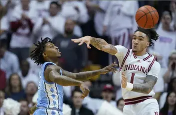  ?? Associated Press ?? North Carolina guard Caleb Love, left, passes the ball past Indiana guard and Pittsburgh native Jalen Hood-Schifino during the second half Nov. 30 in Bloomingto­n, Ind.