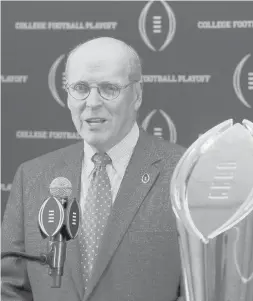  ??  ?? College Football Playoff executive director Bill Hancock, seen at a 2015 news conference, says the national championsh­ip game is still a go for Monday night. Charles Rex Arbogast/AP