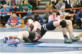  ?? PAUL W. GILLESPIE/CAPITAL GAZETTE PHOTOS ?? Old MIll’s Logan Johnson attempts to pin Marriotts Ridge’s Boden Pistorio in the 106-pound championsh­ip match.