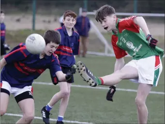  ??  ?? Tomás Mythen blasts the ball to the net past St. Colmcille’s defender Scott Cramer-Walsh.