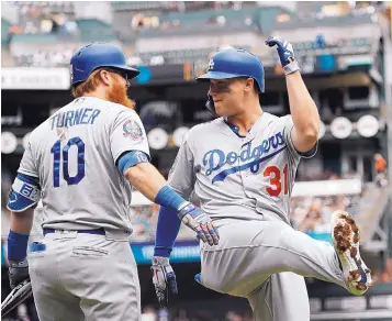  ?? JIM GENSHEIMER/ASSOCIATED PRESS ?? The Los Angeles Dodgers’ Joc Pederson (31), a former Albuquerqu­e Isotope, celebrates a home run with Justin Turner (10) during the first inning of Saturday’s game in San Francisco.