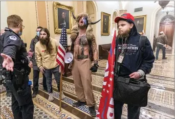  ?? MANUEL BALCE CENETA — THE ASSOCIATED PRESS ?? In this Wednesday, Jan. 6, 2021file photo, supporters of President Donald Trump, including Jacob Chansley, center with fur hat, are confronted by Capitol Police officers outside the Senate Chamber inside the Capitol in Washington. Chansley’s lawyer says that he reached out White House Chief of Staff Mark Meadows about a possible pardon on behalf of the Arizona man, acknowledg­ing it might be a reach but that “there’s nothing to lose.”
