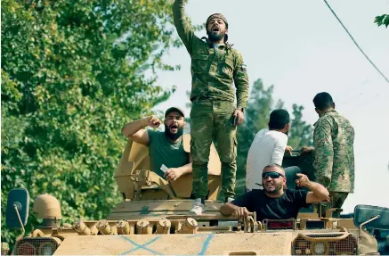  ?? AP ?? Turkish-backed Syrian opposition fighters chant slogans as they wait to cross the border into Syria, in Akcakale, Sanliurfa province, southeaste­rn Turkey, on Friday. —