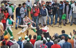  ?? — PTI ?? Farmers play a game as they celebrate after a decision to withdraw farmers-movement in the wake of the government accepting all demands put forward by the agitating farmers at Ghazipur border in New Delhi on Thursday.