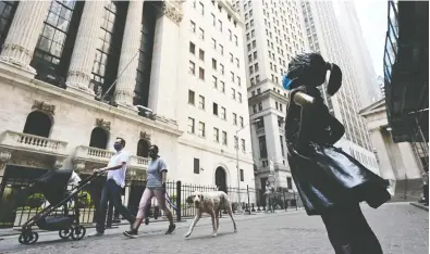  ?? JOHANNES EISELE / AFP VIA GETTY IMAGES FILES ?? Quarantine time has got investment columnist Peter Hodson (and his two teenage sons) thinking about some
of the possible deals that are out there to be made on Wall Street, above, or the TSX.