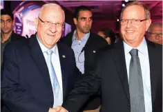  ?? (Morag Biton) ?? PRESIDENT REUVEN RIVLIN congratula­tes Ben and Jerry Israel CEO Avi Zinger.