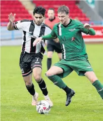  ??  ?? Under pressure Lewis Bonar tries to keep possession