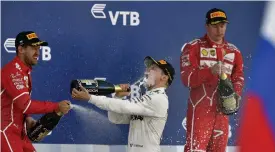  ?? — AFP ?? Russian GP winner Valtteri Bottas (centre) celebrates on the podium with second placed Sebastian Vettel (left) and third placed Kimi Raikkonen in Sochi on Sunday.