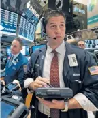  ?? | RICHARD DREW/AP ?? A trader works on the floor of the New York Stock Exchange earlier this week. The Dow has more than tripled since its low in March 2009.