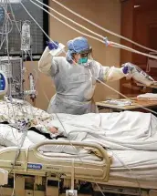  ?? Bob Owen / Staff photograph­er ?? Katherine Hogan tends to a COVID-19 patient at Northeast Baptist Hospital on May 27.