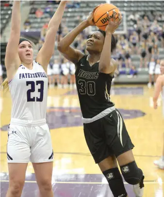  ?? File photo/NWA Democrat-Gazette ?? Bentonvill­e’s Maryam Dauda works for a shot during a game last season. She has already scored already over 1,000 points in her high school career and will try to help the Lady Tigers return to the state finals. The center has committed to Baylor.