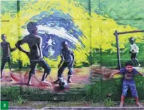  ?? HU JINXI / FOR CHINA DAILY ?? 3. A boy plays in front of a graffiti wall in Sao Paulo. 3