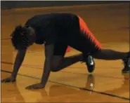  ?? MICHILEA PATTERSON — FOR MEDIANEWS GROUP ?? Pottstown High School student Shameur Delecia, 17, does mountain climbers during a fitness boot camp held at the Olivet Boys &amp; Girls Club Ricketts Center in Pottstown.