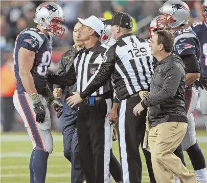  ?? STAFF PHOTO BY MATT STONE ?? UNDER A TIGHT WATCH: Rob Gronkowski gets checked by the officials after taking a hard hit from the Seahawks’ Earl Thomas during the Patriots’ 31-24 loss last night at Gillette Stadium.