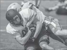  ?? NWA Democrat-Gazette/ANTHONY REYES • @NWATONYR ?? Hunter Garrigas with Bentonvill­e makes a catch against Springdale Har-Ber Monday at a summer team football camp at Wildcat Stadium in Springdale.