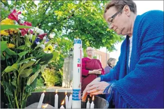  ?? Larry Wong/edmonton Journal/files ?? Rev. Audrey Brooks lights a candle at an inter-faith memorial service held at the University of Alberta in memory of the victims who were gunned down and killed at the university on June 15.