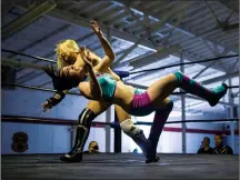  ?? THE CANADIAN PRESS/CHRIS YOUNG ?? Xandra Bale throws Jessie Mack during their bout in a SynRGY Pro Wrestling event at the Oshawa Curling Club on Sunday. The world of female wrestling is changing with expanding audiences and more respect.