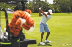  ?? Mike Ehrmann / Getty Images for The Match ?? Tiger Woods warms up on the range prior to a practice round for The Match: Champions For Charity at Medalist Golf Club on Saturday in Hobe Sound, Florida.