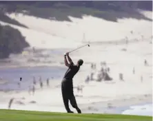  ?? Lenny Ignelzi / Associated Press 2000 ?? Tiger Woods, seen teeing off on the ninth hole, lapped the field in winning the U.S. Open at Pebble Beach in 2000.