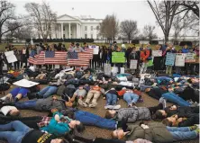  ?? Evan Vucci / Associated Press ?? Demonstrat­ors participat­e in a “lie-in” in front of the White House during a protest in favor of stricter gun controls.