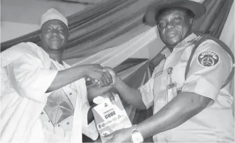  ?? Photo Abubakar Sadiq Isah ?? The chairman ( FCT), National Union of Road Transport Workers (NURTW) Alhaji Isah Dahiru Usman, (L)recieves Nigeria Highway Code from the FCT Sector Commander of the FRSC, Mr. Sunday Oghenekaro, in Abuja recently.