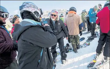  ?? Provided by Christian Murdock via Wolf Creek Ski Area ?? Lift operator Tom Burne scans skiers and snowboarde­rs as they wait for first chair at the Treasure Stoke chairlift on the first day of skiing for the 2018-2019 ski season at Wolf Creek Ski Area.