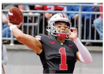  ?? PHOTOS BY DAVID JABLONSKI / STAFF ?? Justin Fields may not have won the quarterbac­k job on the field, but Matthew Baldwin’s request for a transfer has all but cemented him as the Buckeyes’ starter under center.