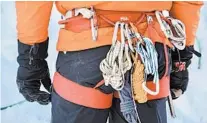  ??  ?? Larry Shiu, a teacher with Yamnuska Mountain Adventures, keeps extra ropes and carabiners on his harness.